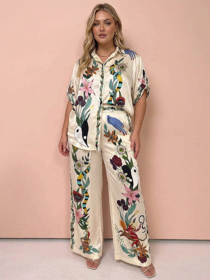 Nika | Set di camicia e pantaloni in satin con stampa unica Vibes Resort